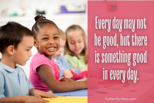 Little girl smiling with other children, with quote overlay