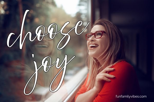 joyful woman looking out the window with quote overlay