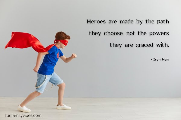 boy wearing superhero cape and mask with quote overlay