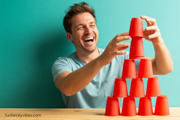 man stacking cups 