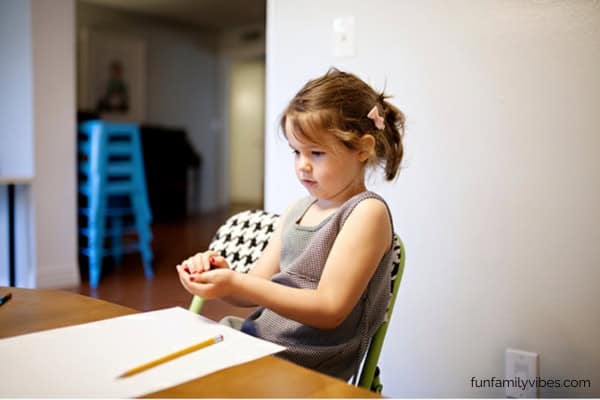 little girl about to roll dice