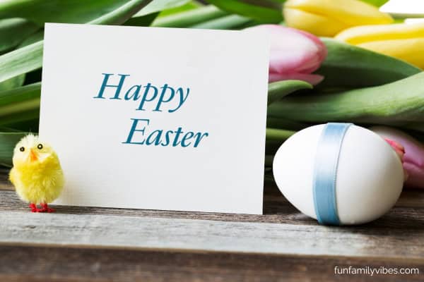 Happy Easter greeting card surrounded by Easter egg, chick, flowers