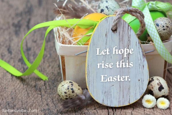 Easter eggs with ribbons with Easter quote on wooden tag