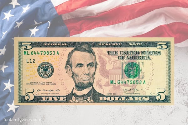 5 dollar bill on American flag background