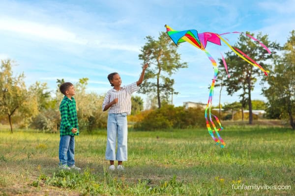 2 kids flying a kite