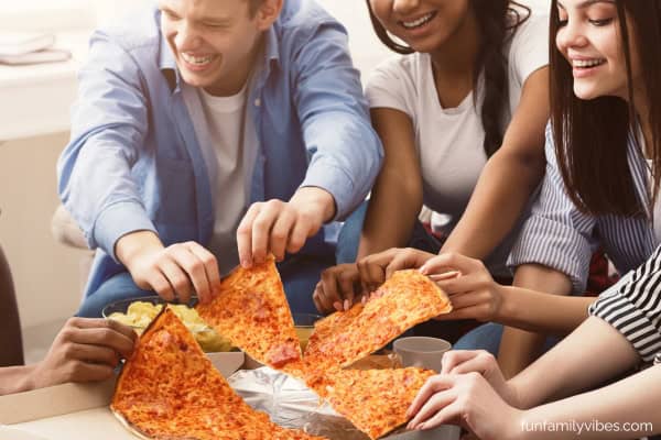group of friends having pizza