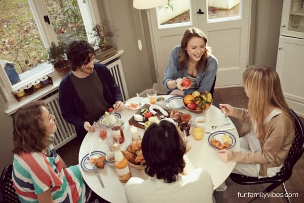 friends sitting around a table laughing