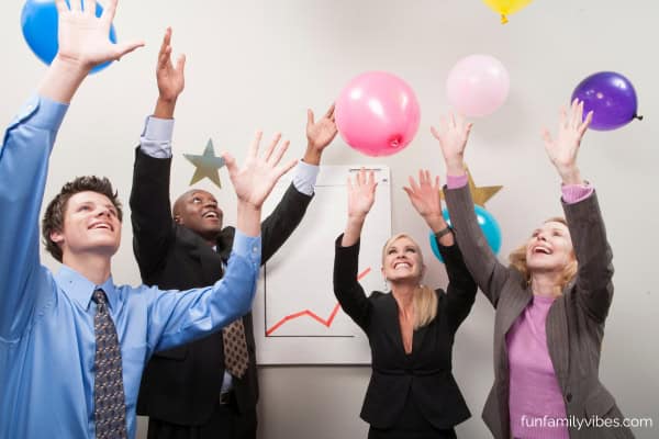 office people tossing balloons