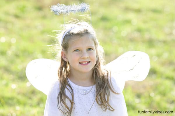 little girl wearing an angel costume