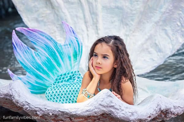 little girl wearing a mermaid costume