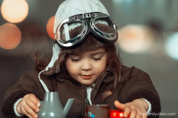 little boy wearing an aviator costume