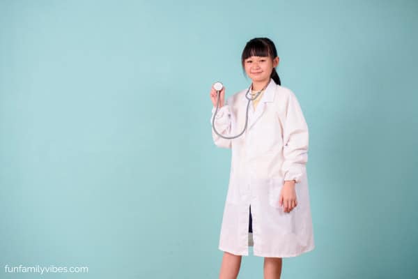 girl wearing a doctor costume with stethoscope