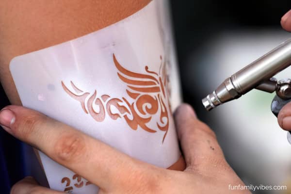 temporary tattoo being applied to arm