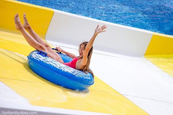 teenage girl on an inflatable ring in a water slide