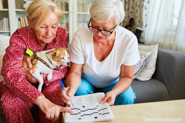 2 women senior citizens working on a crossword puzzle