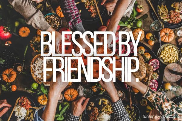 people hands clinking glasses over thanksgiving feast with quote overlay