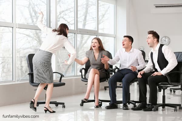 people in an office playing charades
